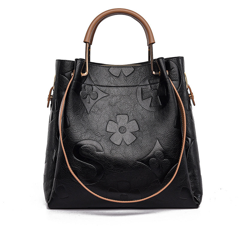 Black handbag with floral patterns