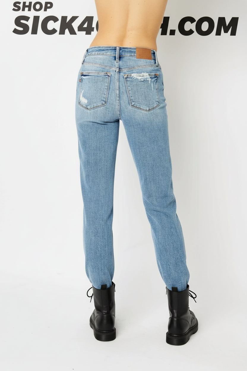 Light blue jeans worn by a person on a white background