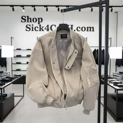 Pilot canvas short and wide jacket in gray hanging in a modern clothing store interior.