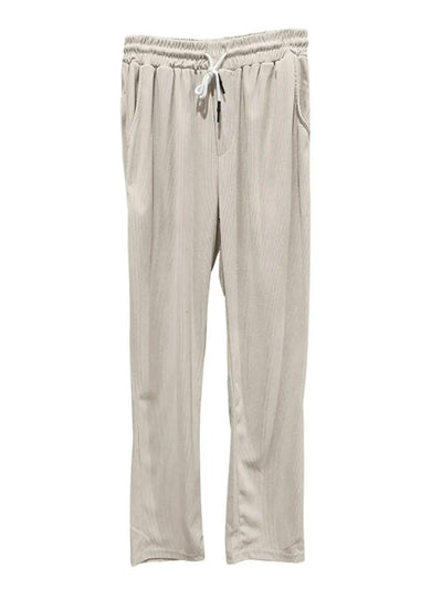 Beige pants with a drawstring on a white background