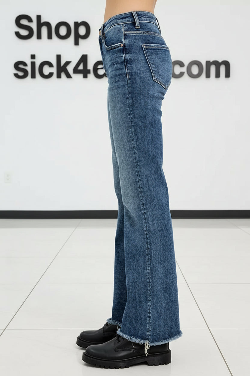 Blue jeans worn by a person on a white background
