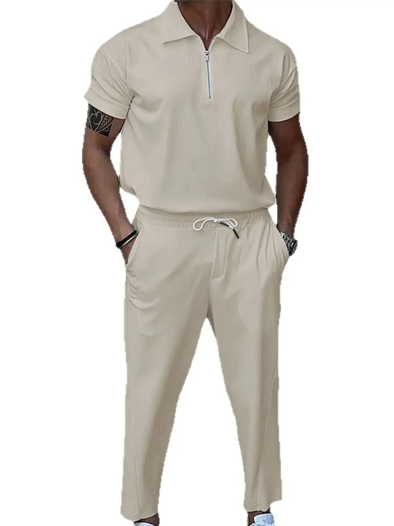 Beige tracksuit worn by a person on a white background