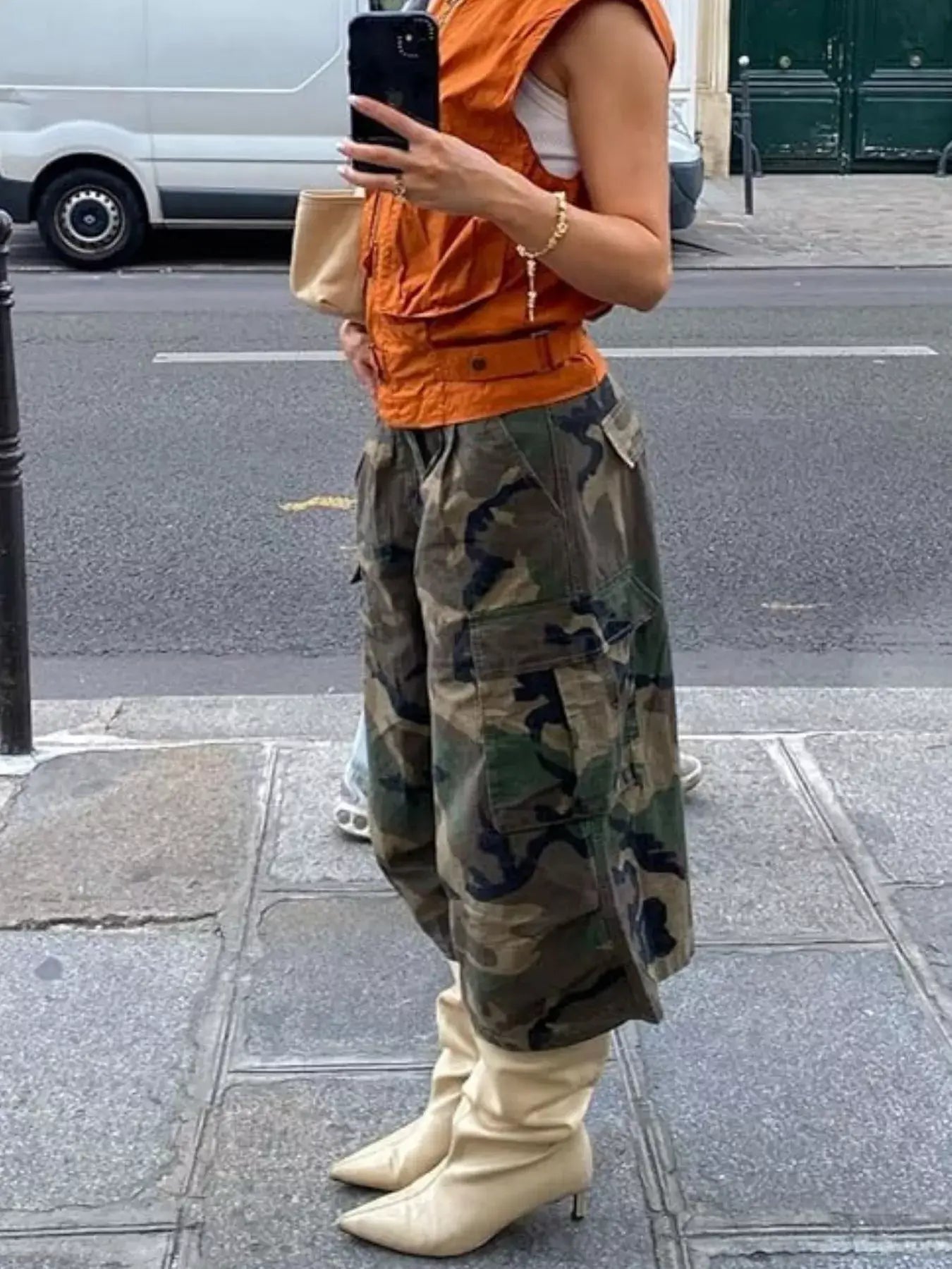 Stylish woman in Camouflage Cargo Cropped Pants and beige boots, showcasing a modern street fashion look.