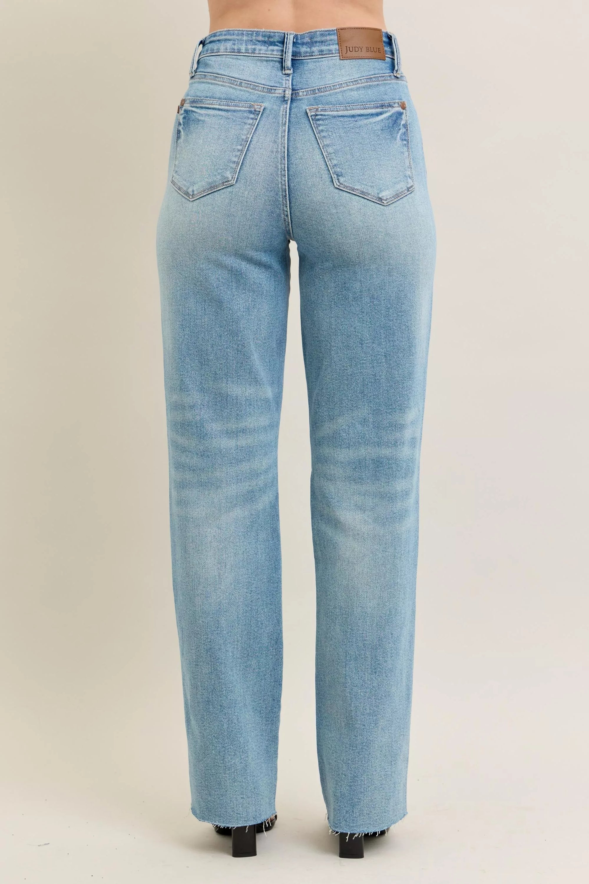 Light blue jeans on a beige background