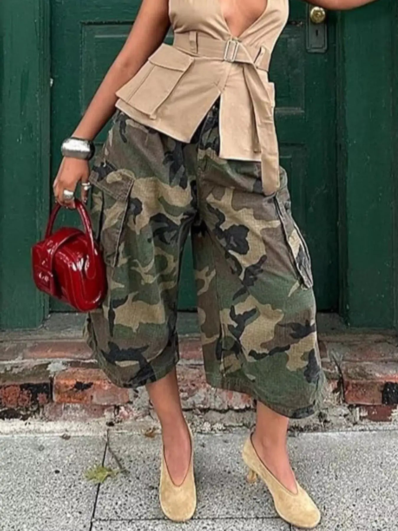 Woman wearing Camouflage Cargo Cropped Pants with a beige top and red handbag, showcasing stylish, casual fashion.