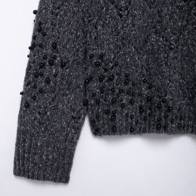 Women's gray asymmetrical knit sweater - close-up of knit texture and details
