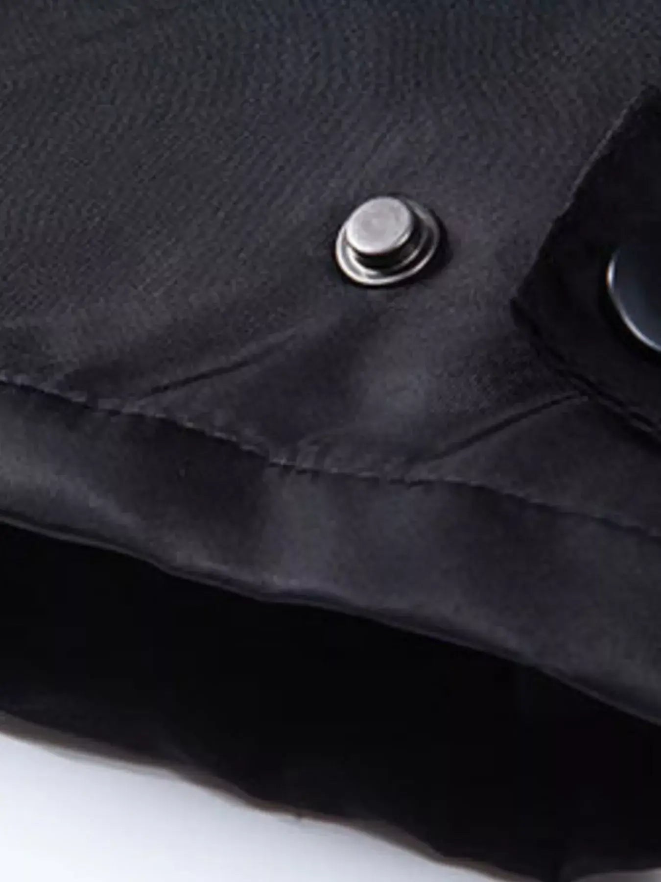 Men's Waterproof Windbreaker Hooded Tactical Jacket detail showing button and zipper fastening in black fabric.