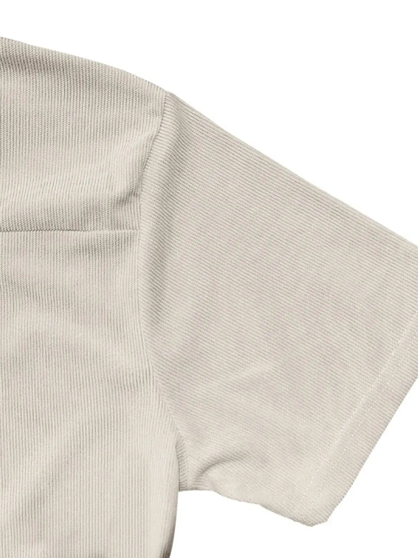 Close-up of a beige ribbed knit fabric on a white background
