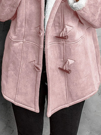 "Close-up of pink toggle coat button detail"