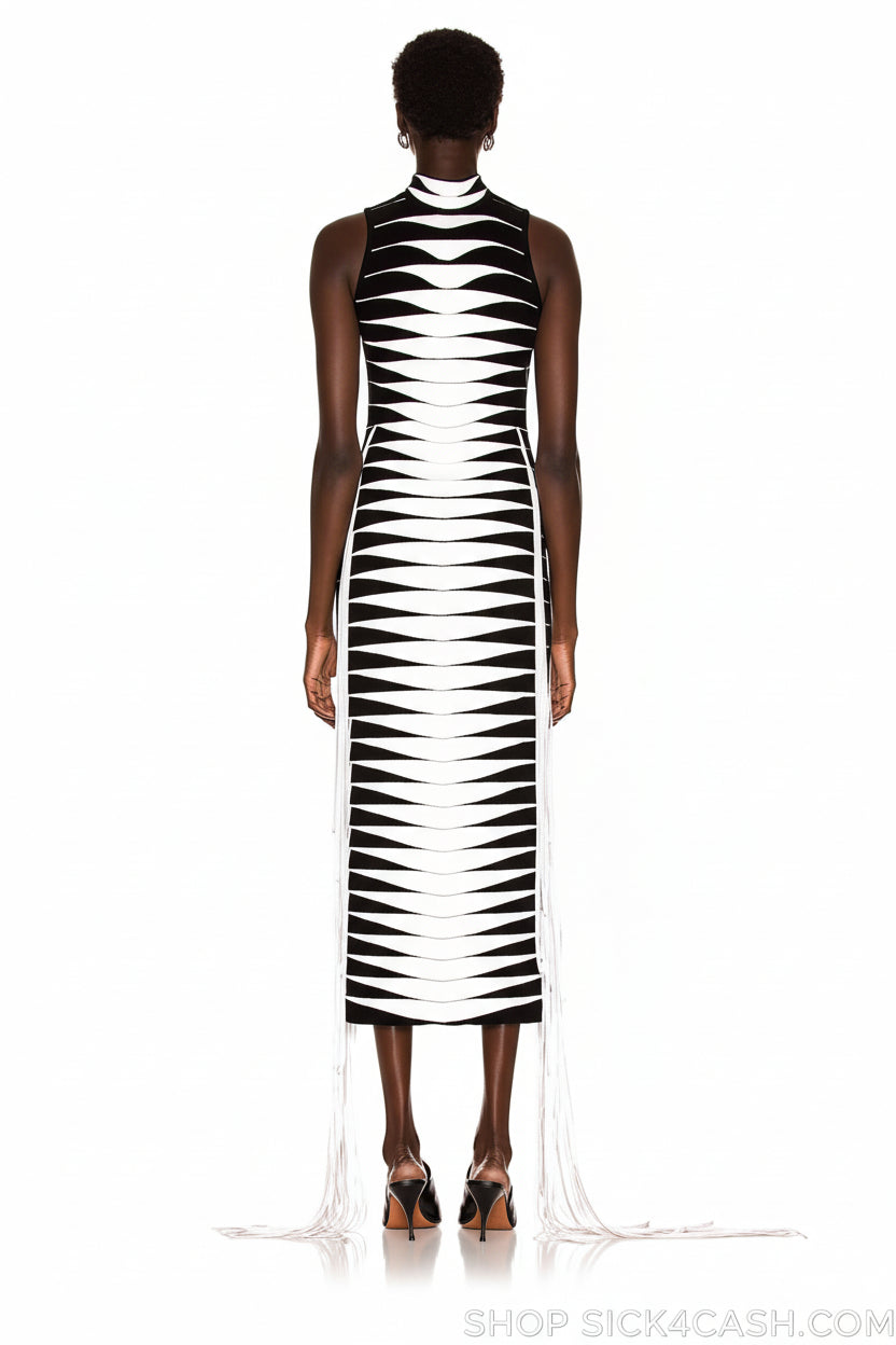 Person wearing a black and white patterned dress on a white background
