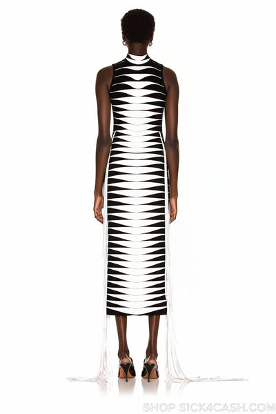 Person wearing a black and white patterned dress on a white background