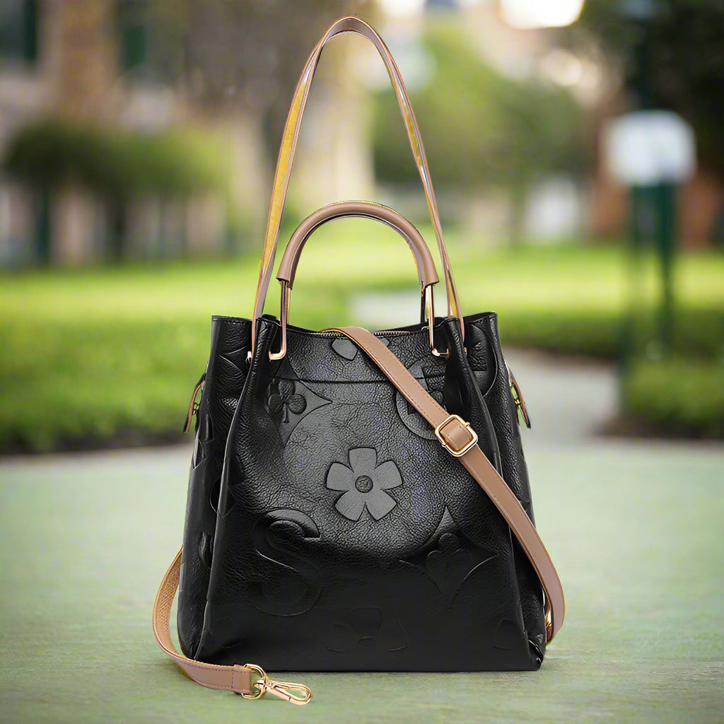 Black handbag with a floral design and brown open
