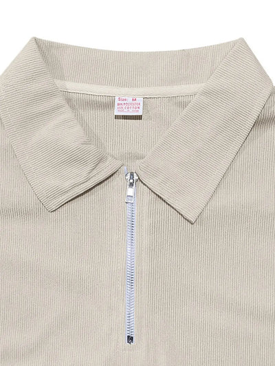 Close-up of a beige ribbed sweater with a collar and zipper on a white background