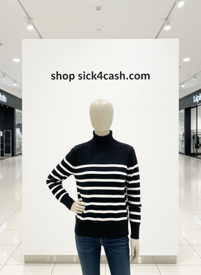 Person wearing a black and white striped sweater against a textured wall.