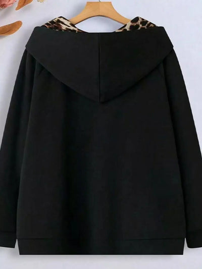 Black hoodie with leopard print hood on a hanger against a white background