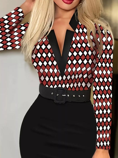 Person wearing a red and black checkered blouse with a black belt against a neutral background