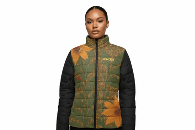 Woman wearing a green and orange patterned puffer vest with black sleeves on a white background