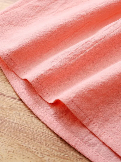 Children's Bow Peter Pan Collar Ruffle Sleeve Dress fabric detail in soft peach color showcasing texture and draping.