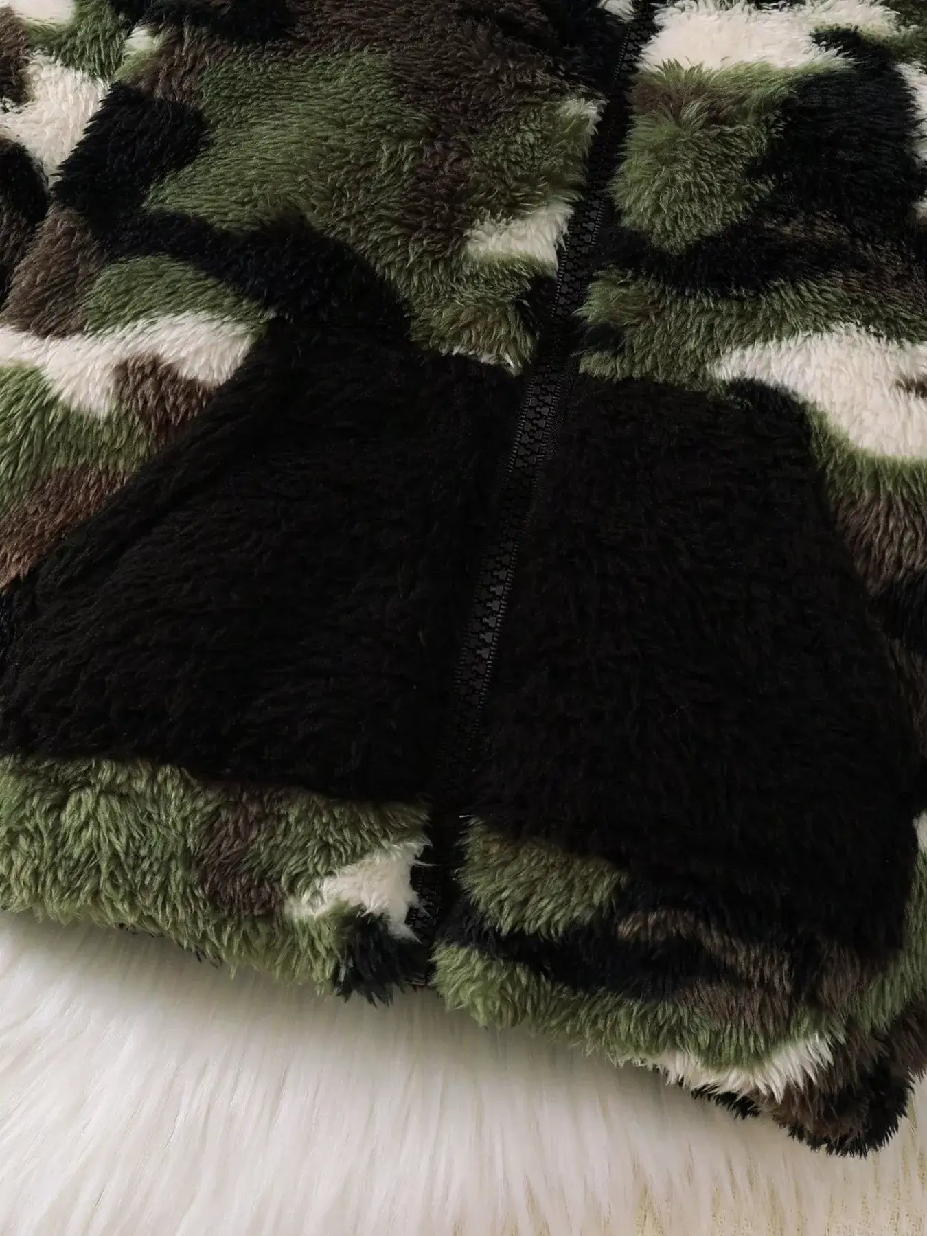 Children's Camouflage Plush Hooded Jacket featuring plush camouflage fabric with pockets and zipper detail.