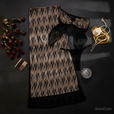 Lace nightgown with matching robe on a white surface with decorative items.