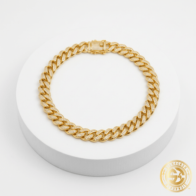 Necklace coiled on white pedestal